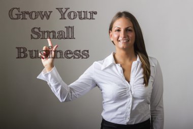 Grow Your Small Business - Beautiful girl touching text on trans