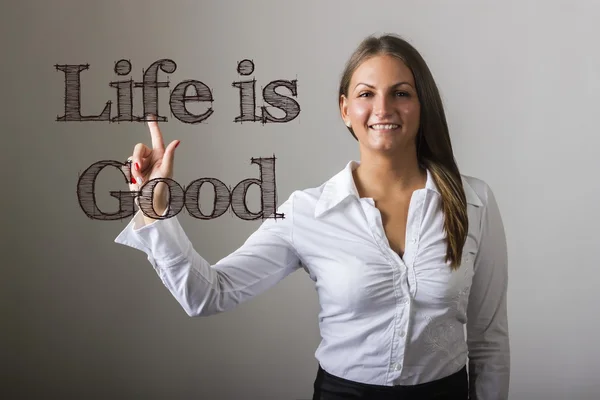 Life is Good - mooi meisje raakt tekst op transparante surfa — Stockfoto