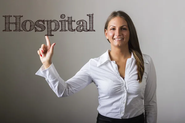 Hospital - Beautiful girl touching text on transparent surface — Stock Photo, Image