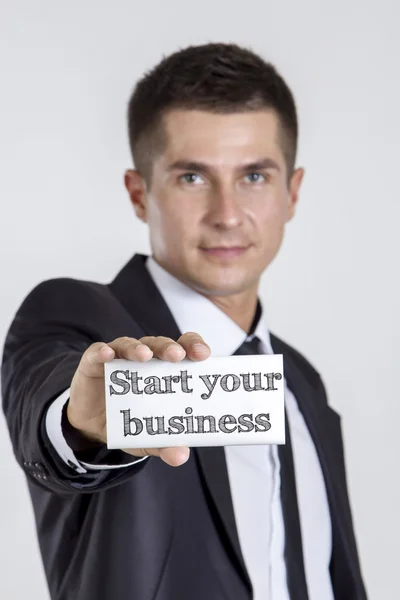 Start your business - Young businessman holding a white card wit — Stock Photo, Image