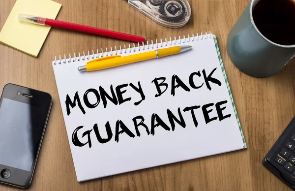 MONEY BACK GUARANTEE - Note Pad With Text On Wooden Table