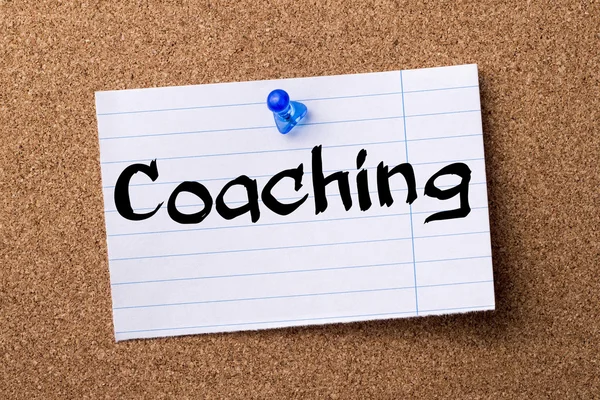 Coaching - teared note paper  pinned on bulletin board — Stock Photo, Image