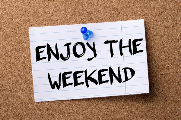 ENJOY THE WEEKEND - teared note paper  pinned on bulletin board — Stock Photo, Image