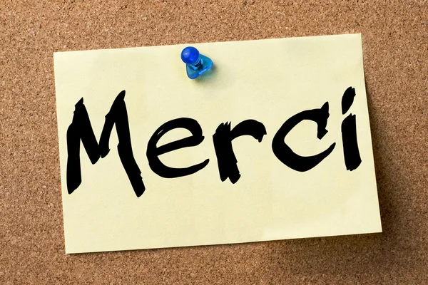 Merci - adhesive label pinned on bulletin board — Stock Photo, Image
