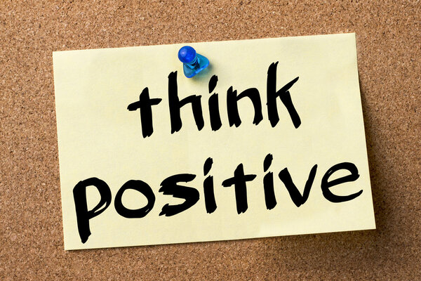 Think Positive - adhesive label pinned on bulletin board