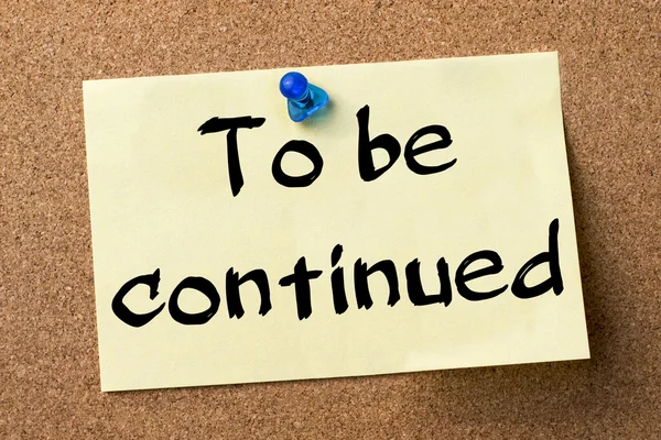 To be continued - adhesive label pinned on bulletin board — Stock Photo, Image