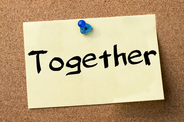 Together - adhesive label pinned on bulletin board