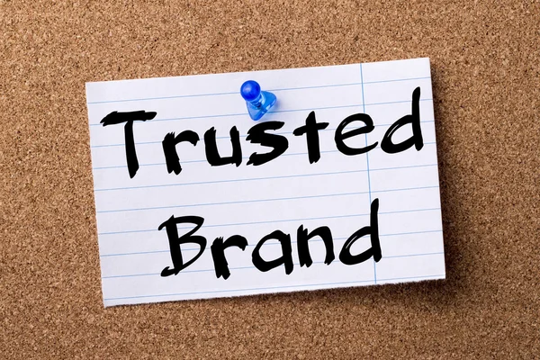 Trusted Brand - teared note paper pinned on bulletin board