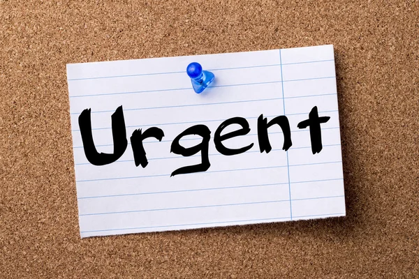 Urgent - teared note paper pinned on bulletin board — Stock Photo, Image