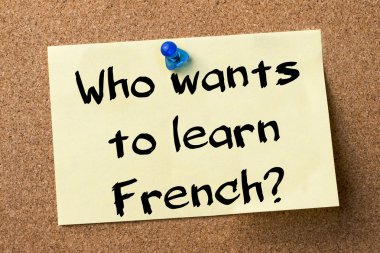 Who wants to learn French? - adhesive label pinned on bulletin b