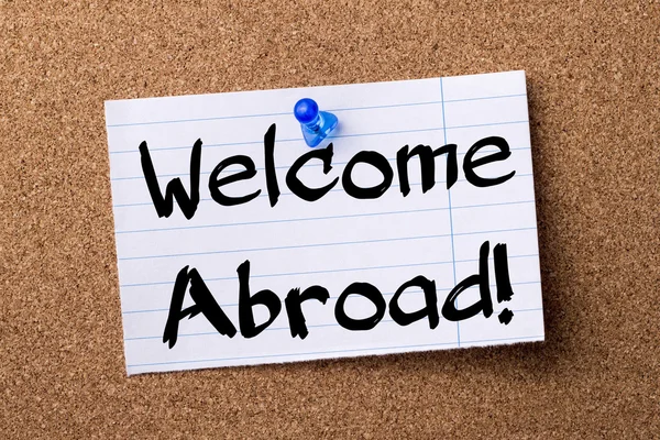 Welcome Abroad! - teared note paper pinned on bulletin board — Stock Photo, Image