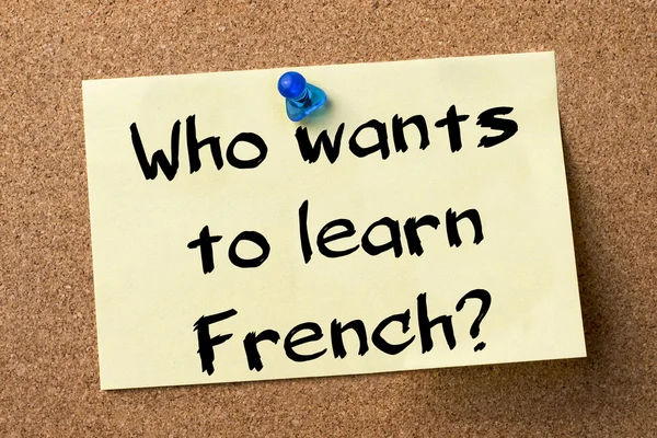 Who wants to learn French? - adhesive label pinned on bulletin b — Zdjęcie stockowe
