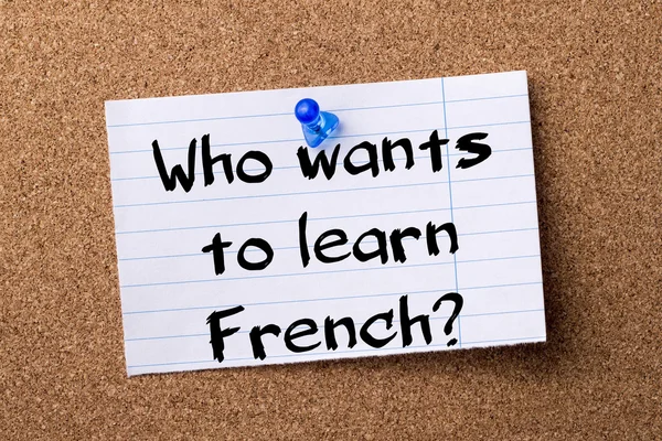 Who wants to learn French? - teared note paper pinned on bulleti — Stock Photo, Image