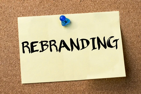 REBRANDING - adhesive label pinned on bulletin board — Stock Photo, Image