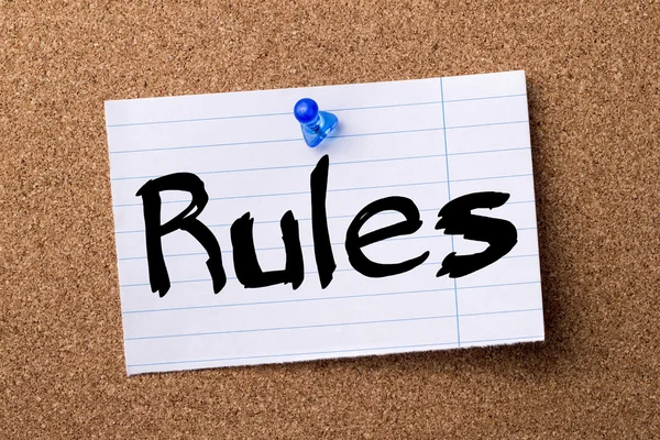Rules - teared note paper pinned on bulletin board — Stock Photo, Image