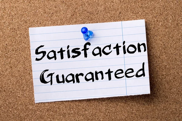 Satisfaction Guaranteed - teared note paper pinned on bulletin b — Stock Photo, Image