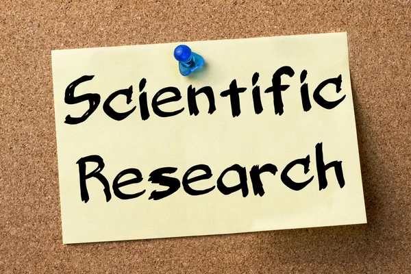 Scientific Research - adhesive label pinned on bulletin board — Stock Photo, Image