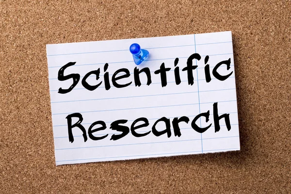 Scientific Research - teared note paper pinned on bulletin board — Stock Photo, Image