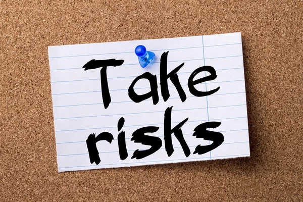 Take risks - teared note paper pinned on bulletin board — Stock Photo, Image