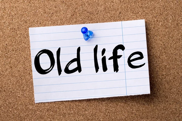 Old life - teared note paper pinned on bulletin board — Stock Photo, Image