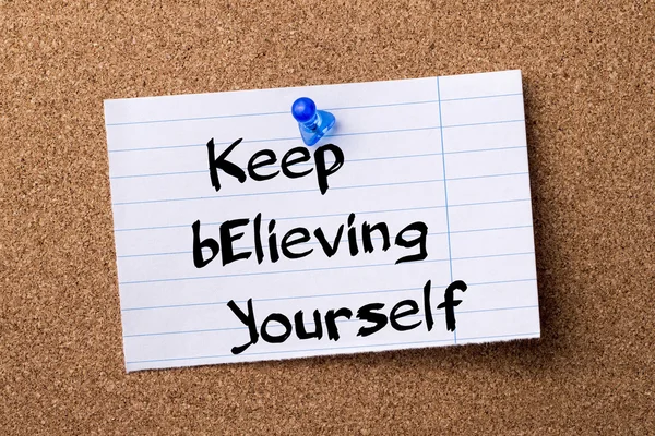 Keep Believing Yourself KEY - teared note paper pinned on bullet — Stock Photo, Image