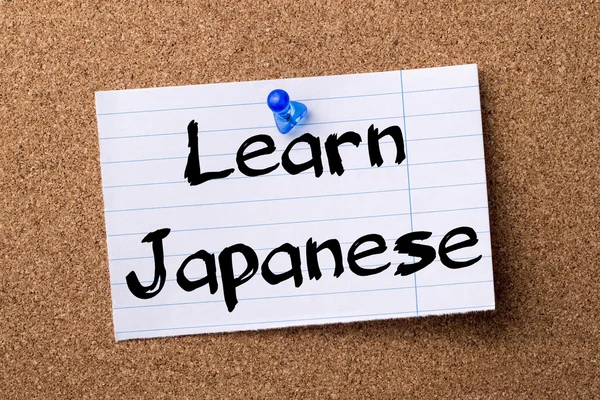 Learn Japanese - teared note paper pinned on bulletin board