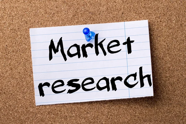 Market research - teared note paper pinned on bulletin board — Stock Photo, Image