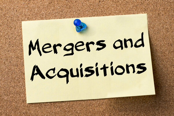 Mergers and Acquisitions - adhesive label pinned on bulletin boa