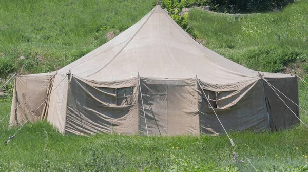 historical reconstruction military tents on green grass meadow