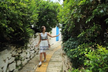 Girit, Yunanistan 'ın güzel dar sokaklarında bir kız yürüyor