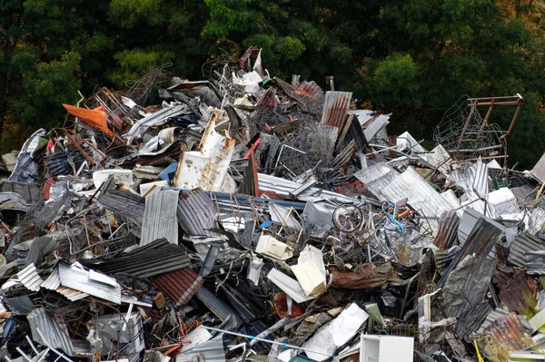 A dump of metal rubbish, man\'s waste accumulating in a large pile