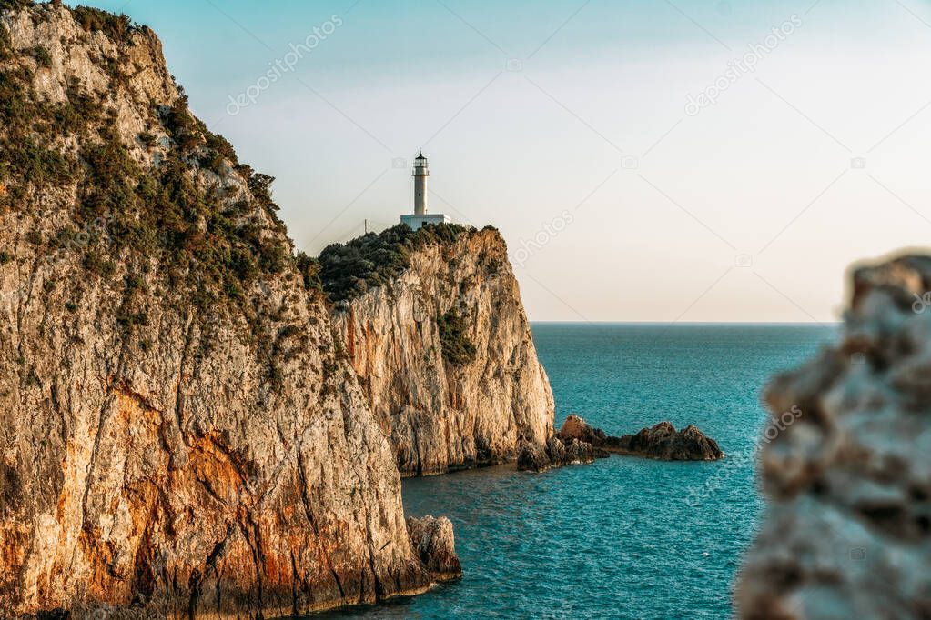 Beautiful lighthouse surrounded by steep cliffs at the most southen part of Lefkada island called Cape Lefkas