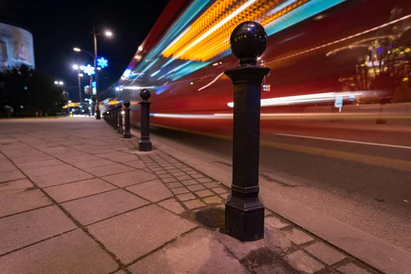 Bollards and light trails from passing vehicles