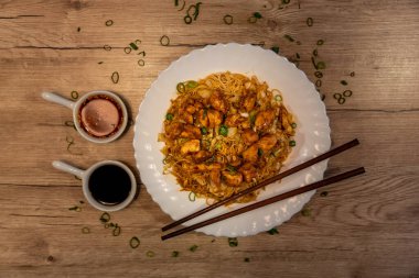 Kızarmış pirinç eriştesi, tavuk ve sebzeli, acılı ve soya soslu.