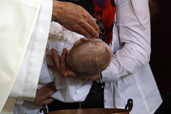 Catholic mass.  Baptism.  Saint-Nicolas de Veroce church. France.