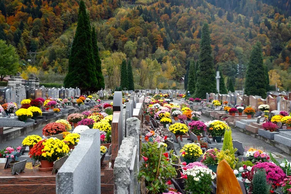 All Saints\' Day at a cemetery. Flowers placed to honor deceased relatives.   France.