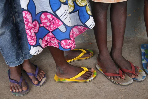 Primary school in Africa. Schoolchildren wearing corlored flip-flops.   Lome. Togo.