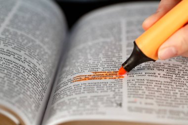 Woman studying the bible. Close up on hand and highlighter.   France.  clipart