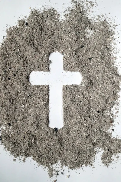 Cross made of ashes. Ash Wednesday. Lent season. France.
