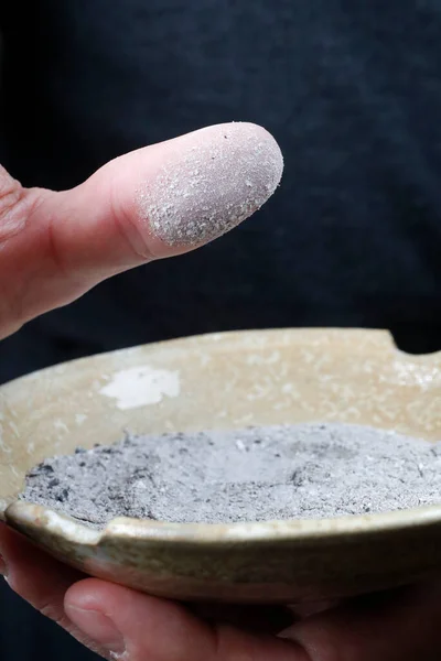 Close-up on hands and ashes.  Ash Wednesday celebration. Lent season. France.