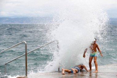 Çocuklar dalgalarla denizde oynuyorlar. Piran. Slovenya. 