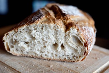 Organic country bread on a cutting board.