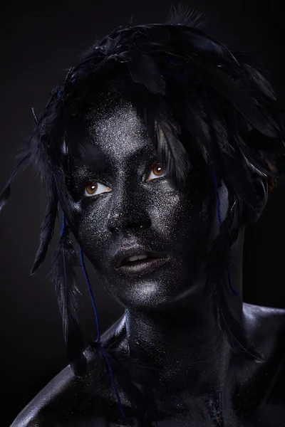 Beautiful woman, black body over dark background, glitters and feathers — 스톡 사진