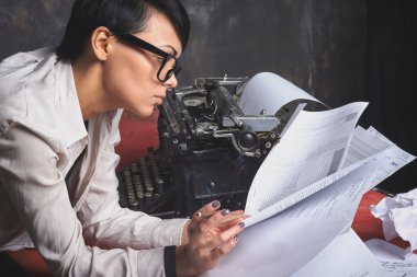 Young stylish woman writer, creative process, work, documents in hand