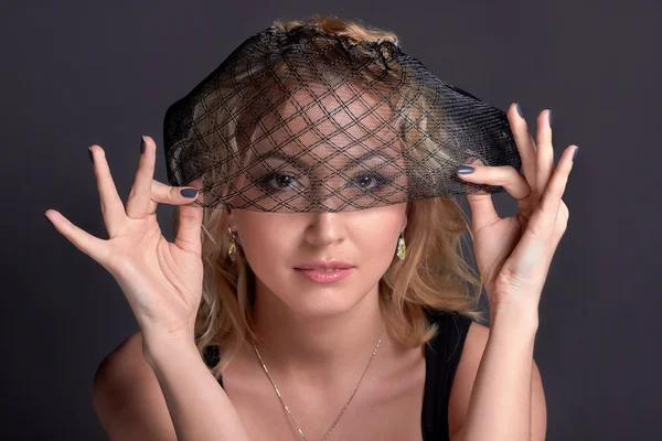 Blond sensual romantic  woman closeup portrait, holding veil, studio photo