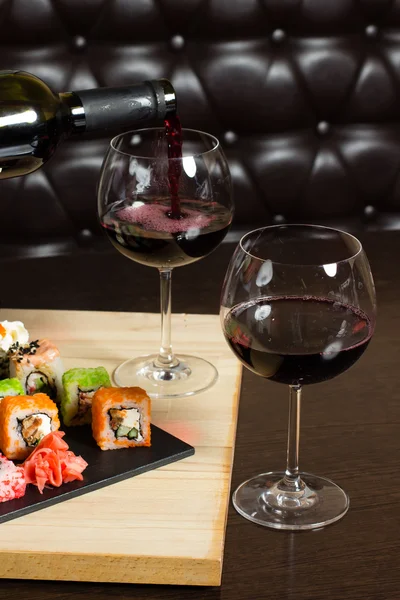 Sushi mix geserveerd diner, rode wijn op tafel in restaurant Rechtenvrije Stockfoto's