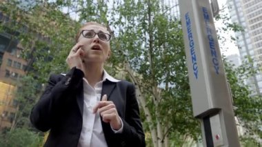 Business woman is a victim of domestic violence and physical abuse calling emergency. Medical Emergency call.