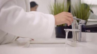 Portrait Of Beautiful woman washing her face in the bathroom. Facial Skin.