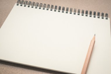Masanın üzerinde kahverengi kalem ile boş defter kağıt