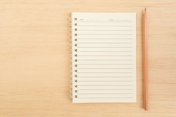 Top view of open spiral line paper notebook and brown pencil on — Stock Photo, Image